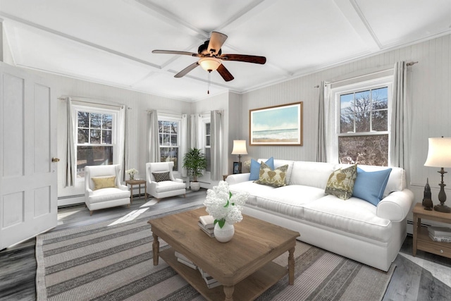 living room with a ceiling fan, dark wood-style flooring, crown molding, and baseboard heating