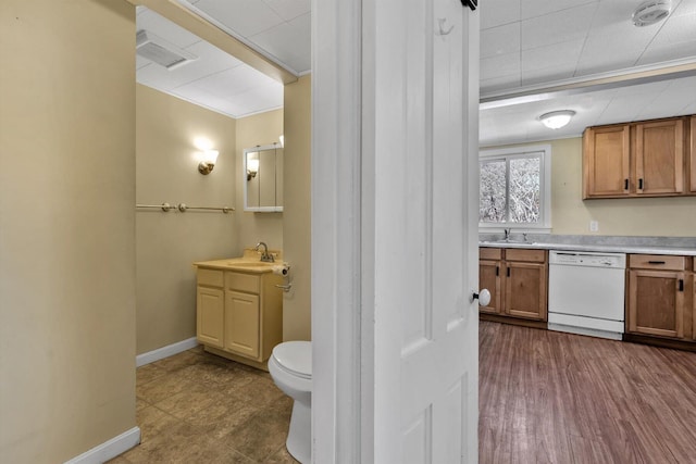 bathroom featuring toilet, wood finished floors, vanity, baseboards, and ornamental molding