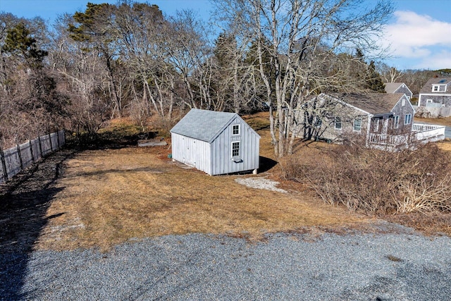 view of yard with a shed, fence, and an outdoor structure