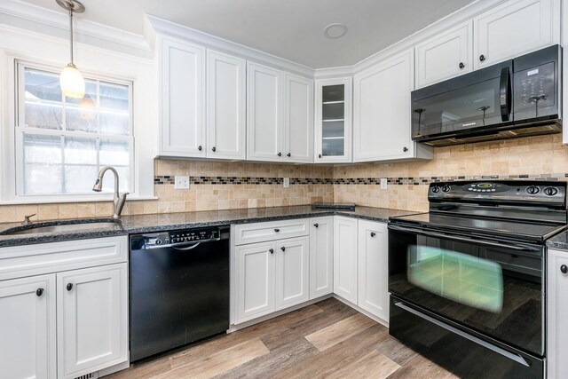 kitchen featuring black appliances, white cabinetry, light hardwood / wood-style floors, and sink