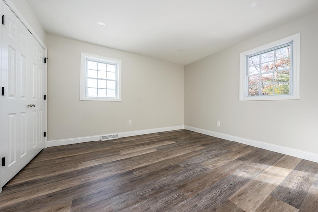 unfurnished bedroom with dark wood-type flooring