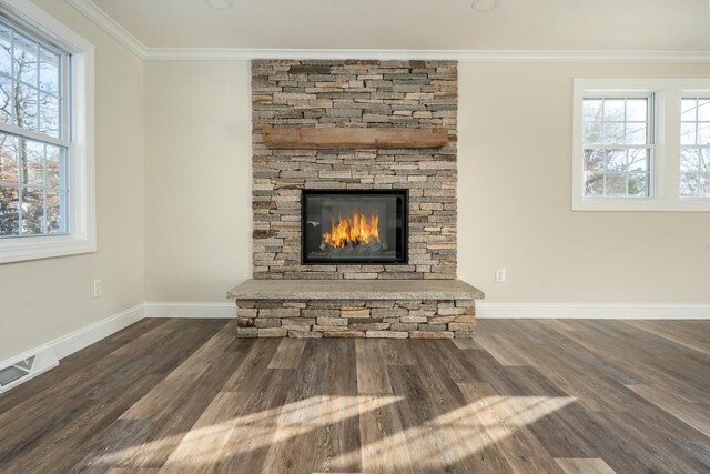 unfurnished living room featuring a healthy amount of sunlight, dark hardwood / wood-style flooring, and ornamental molding