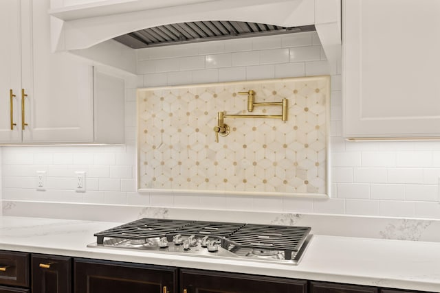 7 Nicklaus Way, Mashpee, MA 02649 - kitchen with stainless steel gas cooktop, light countertops, premium range hood, decorative backsplash, and white cabinets
