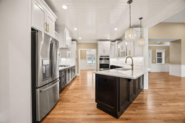 7 Nicklaus Way, Mashpee, MA 02649 - kitchen with appliances with stainless steel finishes, white cabinets, light countertops, a sink, and light wood-type flooring