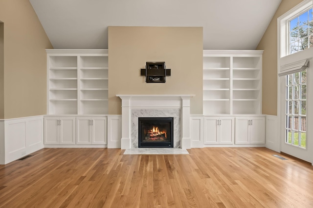 7 Nicklaus Way, Mashpee, MA 02649 - unfurnished living room featuring wood finished floors, a premium fireplace, vaulted ceiling, and built in features