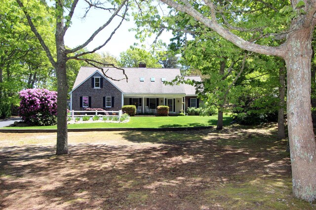 473 Thousand Oaks Dr, Brewster, MA 02631 - new england style home with a chimney and a front yard