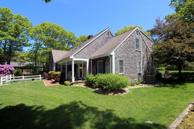 473 Thousand Oaks Dr, Brewster, MA 02631 - rear view of house with a chimney, central AC unit, and roof with shingles
