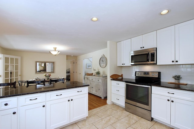 473 Thousand Oaks Dr, Brewster, MA 02631 - kitchen with stainless steel appliances, white cabinetry, backsplash, and recessed lighting
