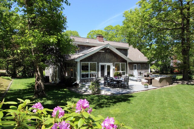 473 Thousand Oaks Dr, Brewster, MA 02631 - rear view of house featuring outdoor lounge area, a patio area, a chimney, and a yard