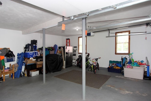 473 Thousand Oaks Dr, Brewster, MA 02631 - garage featuring stainless steel fridge with ice dispenser and a garage door opener