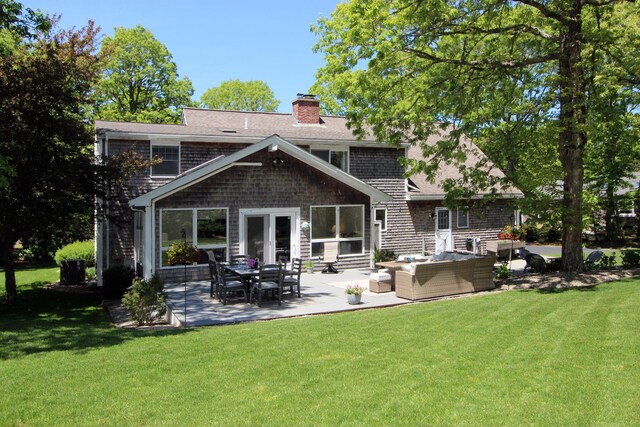 473 Thousand Oaks Dr, Brewster, MA 02631 - rear view of house featuring an outdoor living space, a yard, a patio, and a chimney