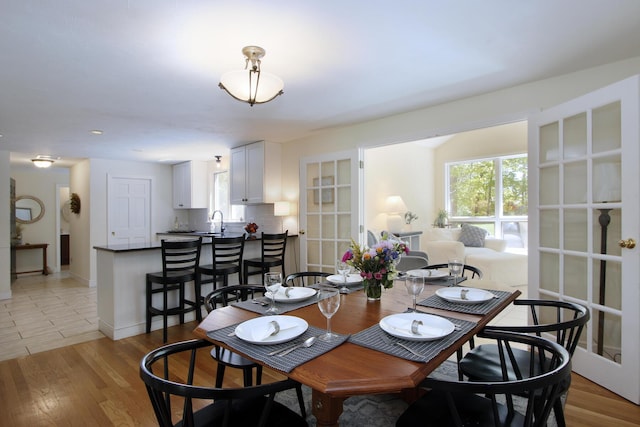 473 Thousand Oaks Dr, Brewster, MA 02631 - dining room featuring healthy amount of natural light, light wood finished floors, and baseboards