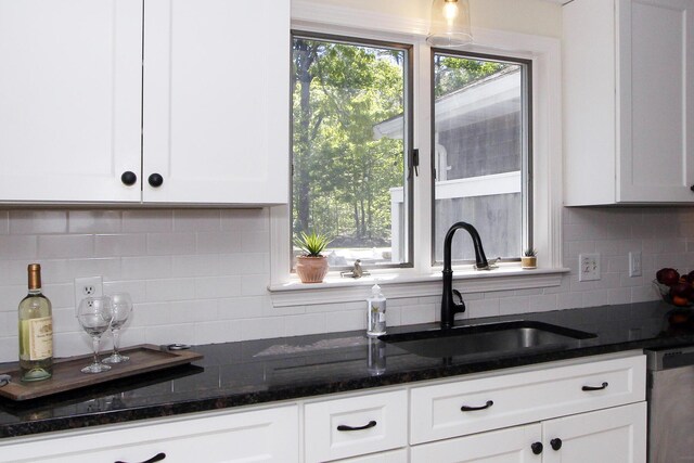 473 Thousand Oaks Dr, Brewster, MA 02631 - kitchen with stainless steel dishwasher, a sink, white cabinets, and backsplash
