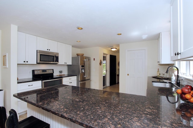 473 Thousand Oaks Dr, Brewster, MA 02631 - kitchen featuring stainless steel appliances, a sink, healthy amount of natural light, white cabinetry, and recessed lighting