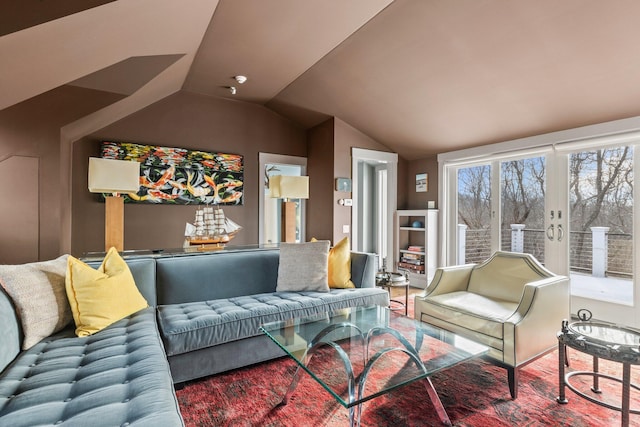 living room featuring vaulted ceiling and french doors