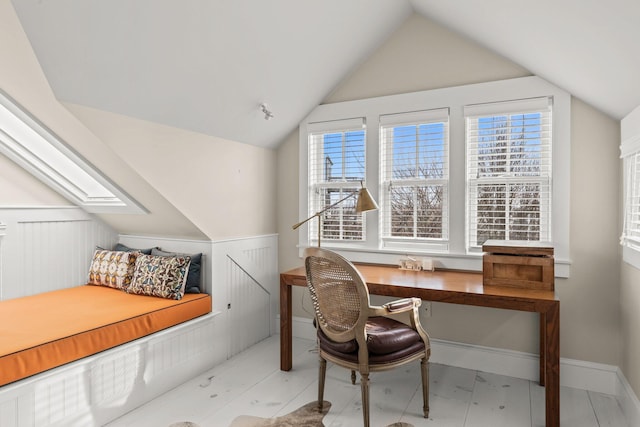 office area with vaulted ceiling with skylight and a wealth of natural light
