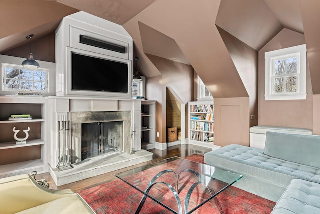 living room with a fireplace, hardwood / wood-style floors, plenty of natural light, and lofted ceiling
