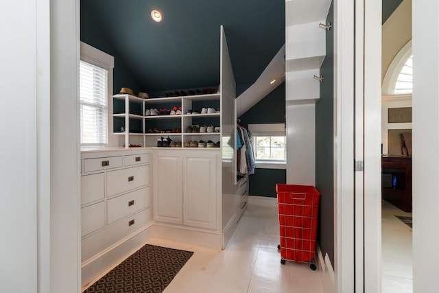 walk in closet featuring lofted ceiling