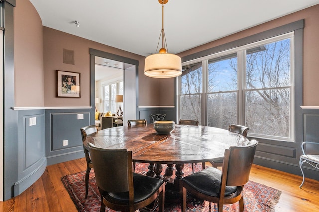 dining space featuring wood-type flooring