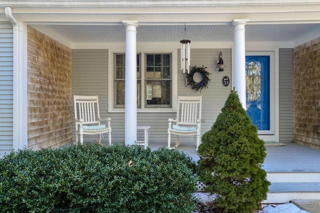 view of exterior entry with a porch