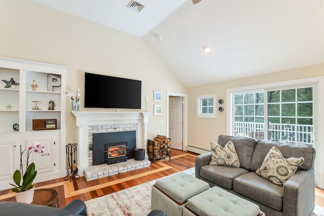 living area with visible vents, wood finished floors, a baseboard heating unit, and vaulted ceiling