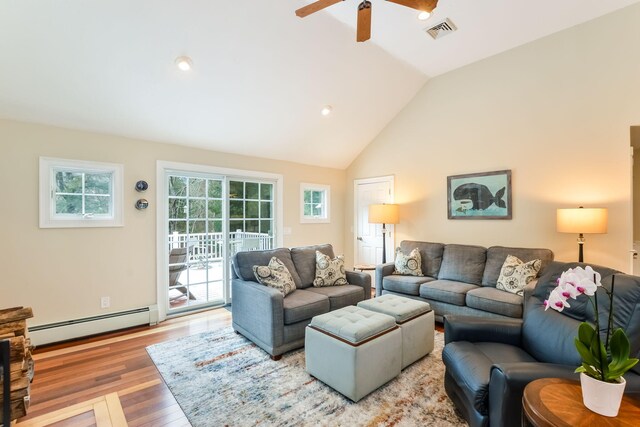 living room with visible vents, ceiling fan, baseboard heating, wood finished floors, and high vaulted ceiling