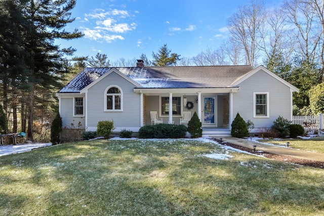 ranch-style house featuring fence, roof with shingles, covered porch, a chimney, and a front lawn