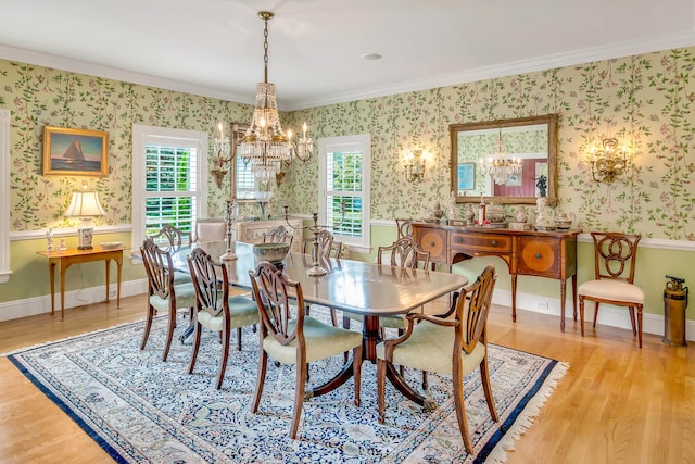 dining space featuring crown molding, a wealth of natural light, a notable chandelier, and light wood-type flooring