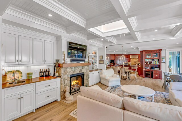 44 Seapuit Rd, Osterville, MA 02655 - living area featuring light wood-type flooring, a fireplace, coffered ceiling, crown molding, and recessed lighting