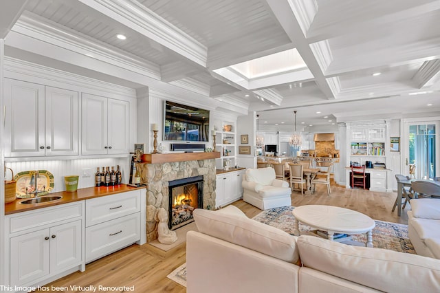 44 Seapuit Rd, Osterville, MA 02655 - living area featuring light wood-type flooring, a fireplace, coffered ceiling, crown molding, and recessed lighting