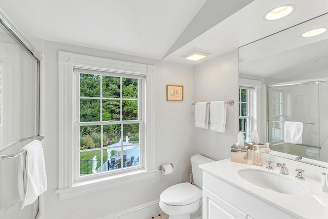 bathroom with a wealth of natural light, vaulted ceiling, and a shower with door