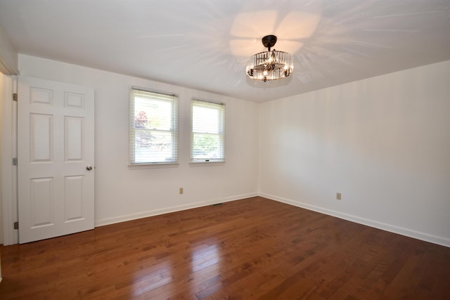 8 Great Rock Rd, Bourne, MA 02532 - unfurnished room with a chandelier, dark wood-type flooring, and baseboards