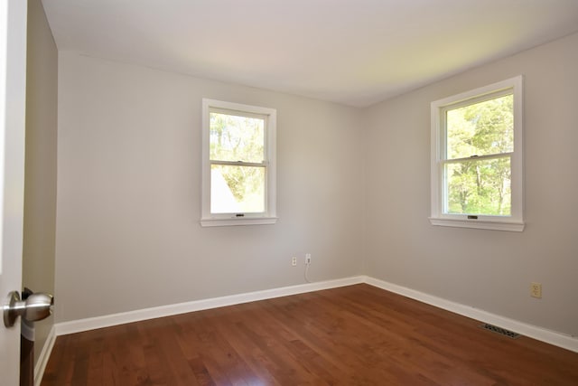 8 Great Rock Rd, Bourne, MA 02532 - spare room with healthy amount of natural light, dark wood-style flooring, and baseboards