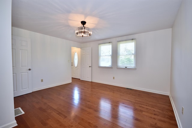 8 Great Rock Rd, Bourne, MA 02532 - empty room featuring plenty of natural light, a chandelier, wood finished floors, and baseboards