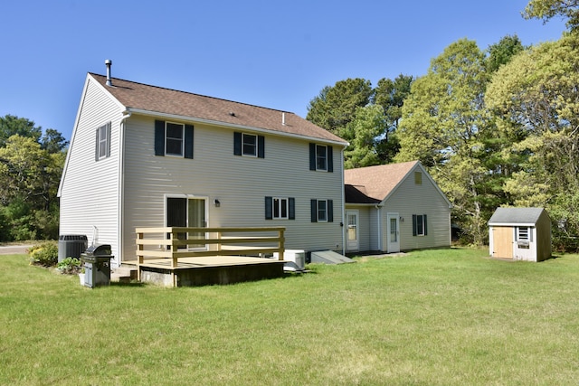 8 Great Rock Rd, Bourne, MA 02532 - back of house featuring a storage unit, a lawn, central air condition unit, and an outbuilding