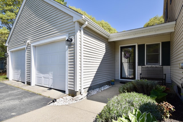 8 Great Rock Rd, Bourne, MA 02532 - view of exterior entry with asphalt driveway and an attached garage
