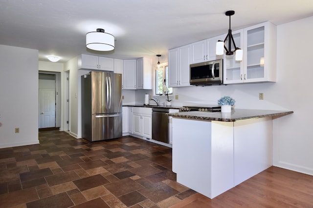 8 Great Rock Rd, Bourne, MA 02532 - kitchen with stainless steel appliances, a peninsula, glass insert cabinets, and white cabinetry