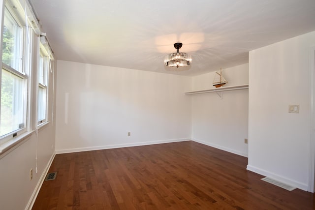 8 Great Rock Rd, Bourne, MA 02532 - unfurnished room featuring a chandelier, plenty of natural light, and dark wood finished floors