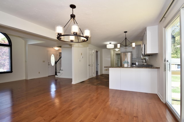 8 Great Rock Rd, Bourne, MA 02532 - kitchen featuring a chandelier, dark wood finished floors, a peninsula, stainless steel appliances, and healthy amount of natural light