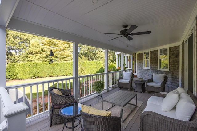 sunroom / solarium featuring ceiling fan