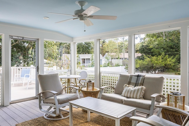 sunroom with ceiling fan and lofted ceiling