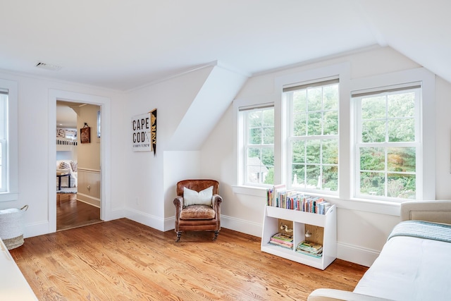 sitting room featuring vaulted ceiling and light hardwood / wood-style floors