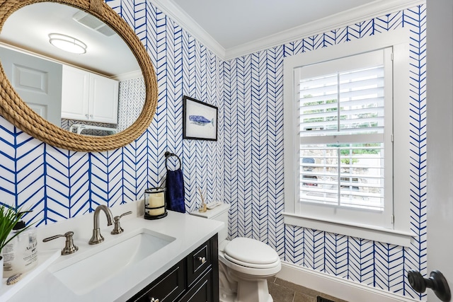 bathroom with tile patterned floors, toilet, vanity, and ornamental molding