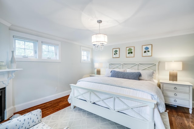 bedroom with dark wood-type flooring, crown molding, and a chandelier