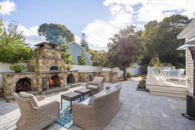 view of patio / terrace featuring an outdoor stone fireplace