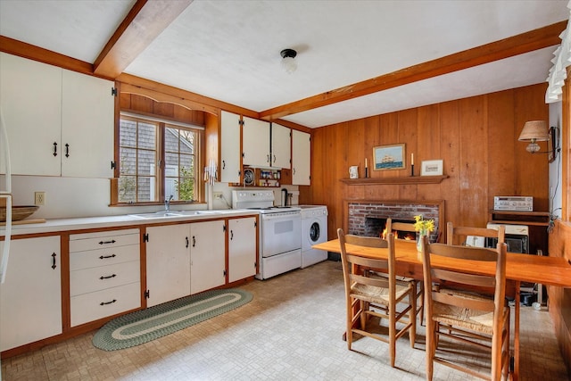 495 Chequessett Neck Rd, Wellfleet, MA 02667 - kitchen with washer / clothes dryer, beamed ceiling, a sink, wood walls, and white range with electric cooktop