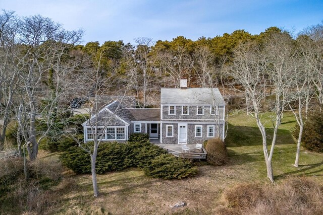 495 Chequessett Neck Rd, Wellfleet, MA 02667 - back of property with a lawn, a deck, a chimney, and a wooded view