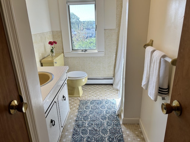 bathroom featuring a baseboard radiator, toilet, tile patterned floors, and vanity