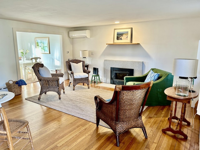 living area featuring a wall mounted AC and hardwood / wood-style floors