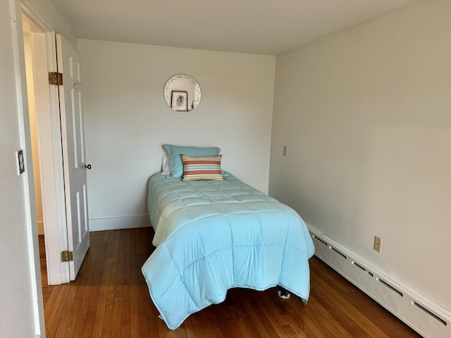 bedroom featuring a baseboard radiator and dark wood-type flooring